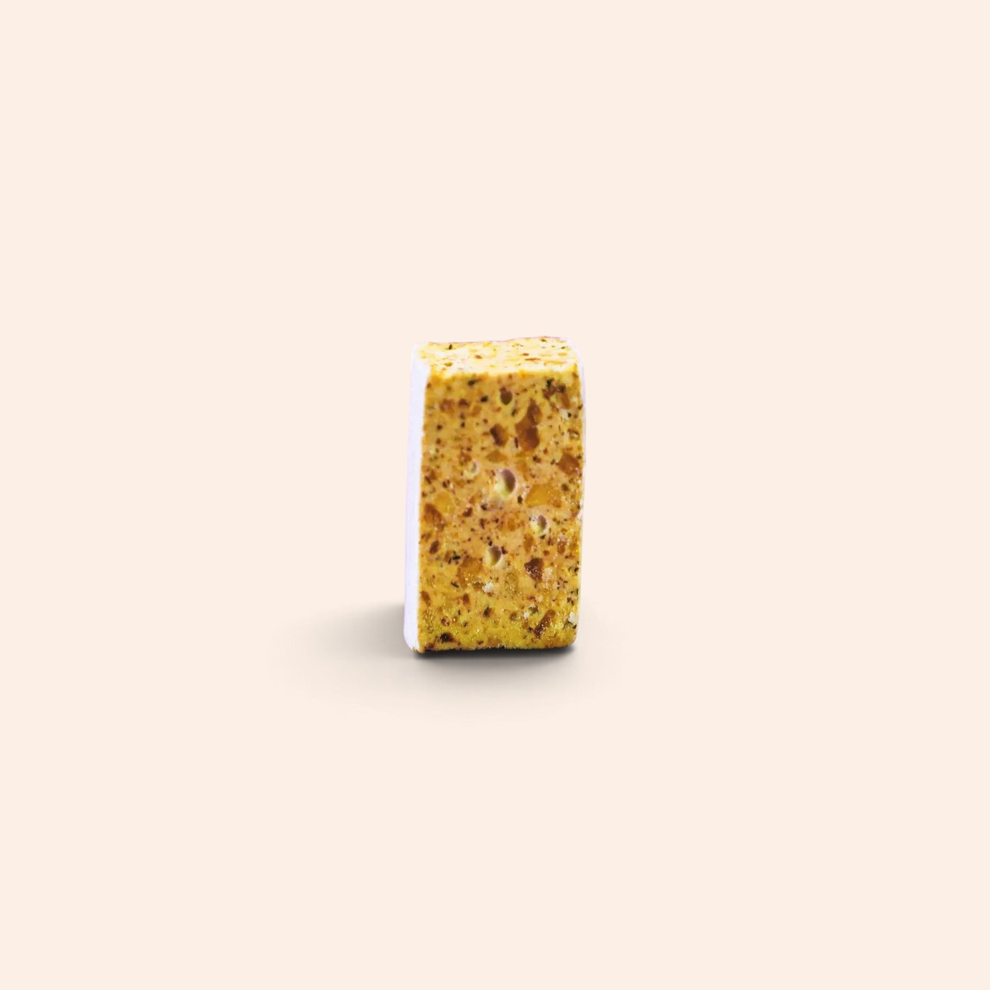 Morceau de nougat aux noisettes Maison Fruidoraix à la texture tendre et croquante sur fond beige
