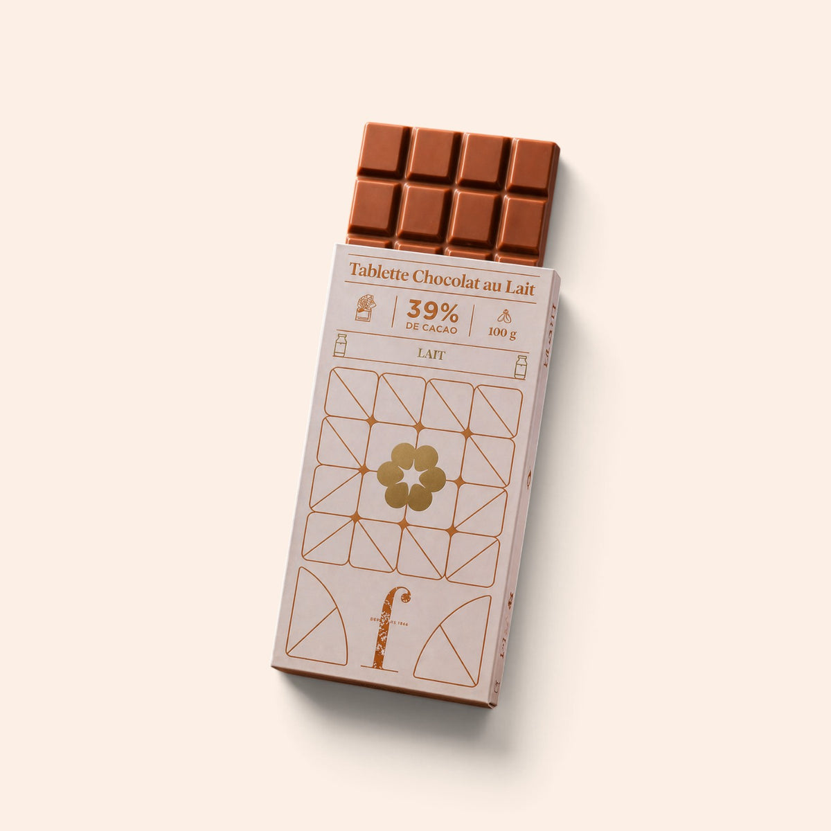 Tablette de chocolat au lait Maison Fruidoraix 39% cacao dans son emballage élégant aux motifs géométriques dorés